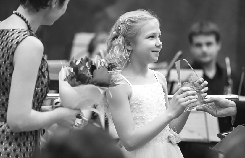 Alisa receiving applause and flowers after a performance