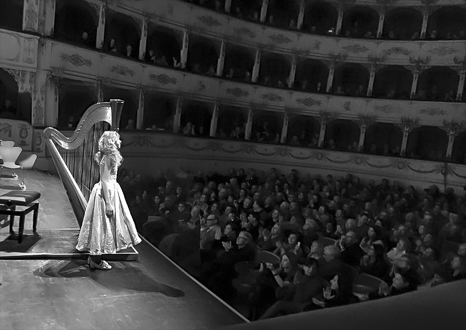 Alisa on stage in front of a concert hall audience