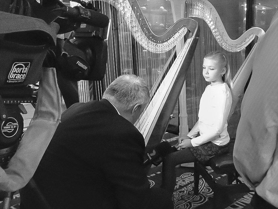 Young Alisa at her harp during a rehearsal